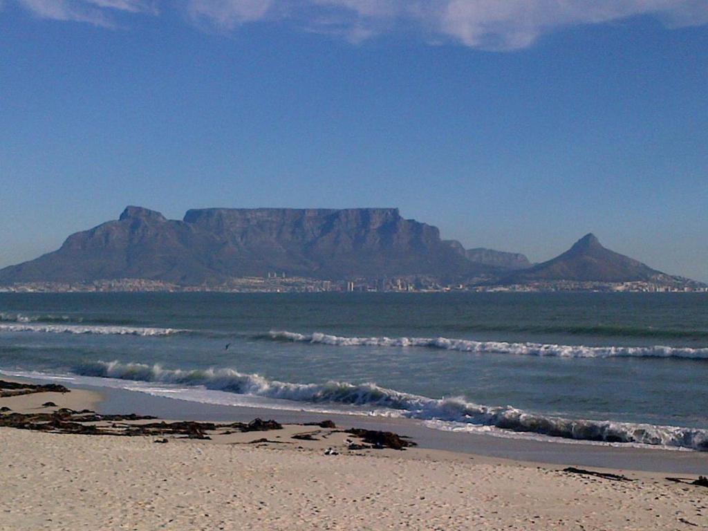 a view of a beach with a mountain in the background at Blouberg Manor in Bloubergstrand