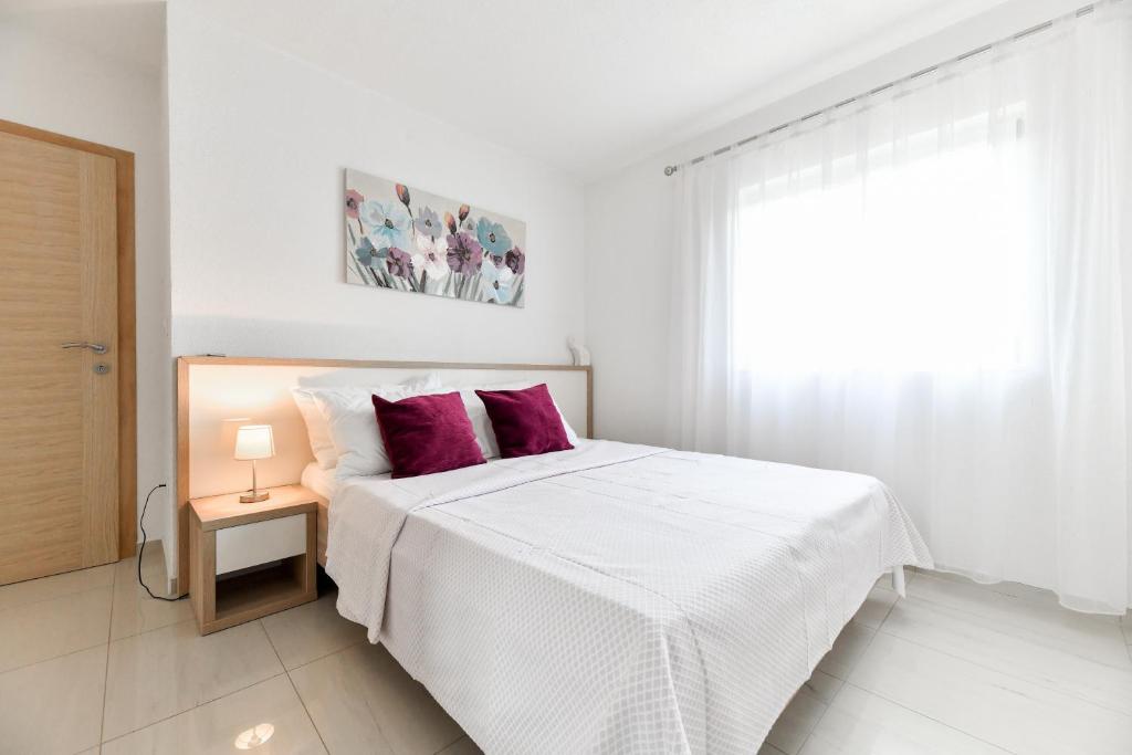 Posteľ alebo postele v izbe v ubytovaní Apartments Diora