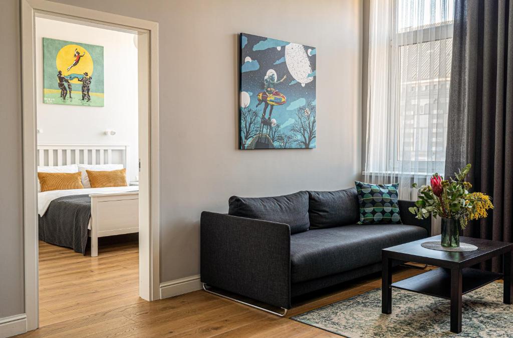 a living room with a couch and a table at Beautiful apartment in the heart of Kaunas in Kaunas