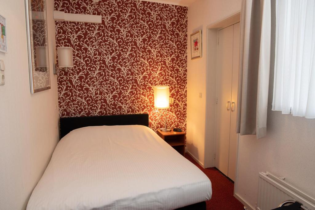 Postel nebo postele na pokoji v ubytování Die Port van Cleve