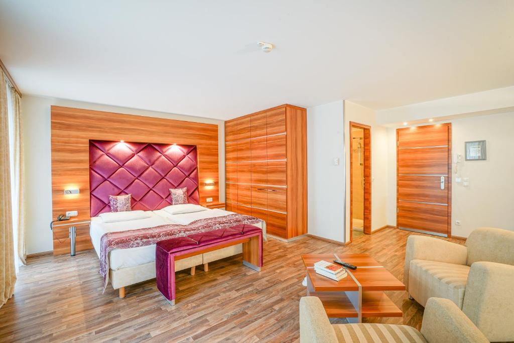 a hotel room with a bed and a couch at Arkona Strandresidenzen in Binz