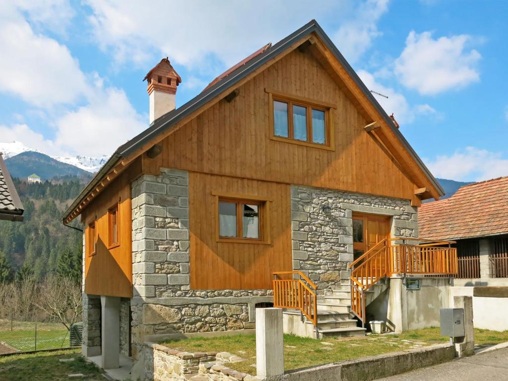 a stone and wood house with a chimney at Holiday Home Stali di Ettore by Interhome in Ovaro