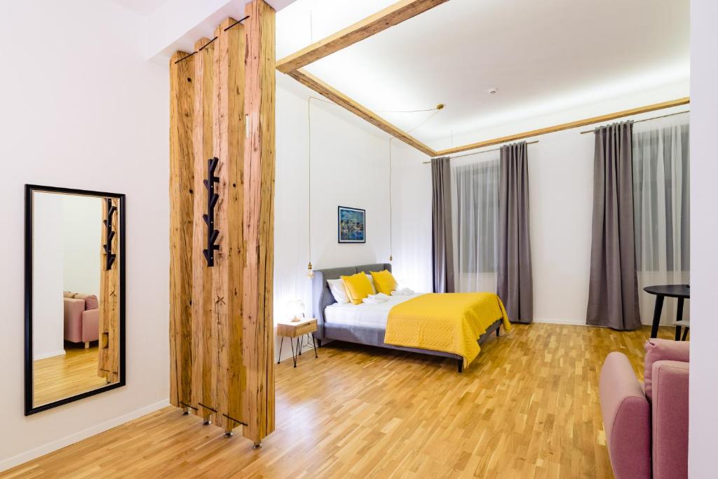 a bedroom with a bed and a mirror at Pensiunea Salina Gymnasium in Turda