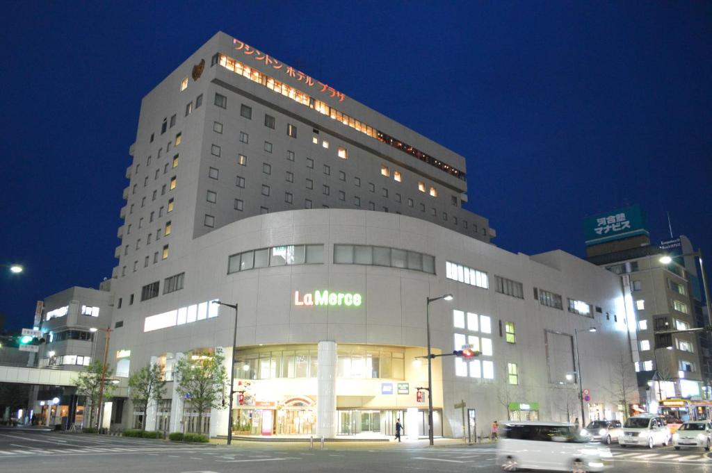 a building with a car driving in front of it at Takasaki Washington Hotel Plaza in Takasaki