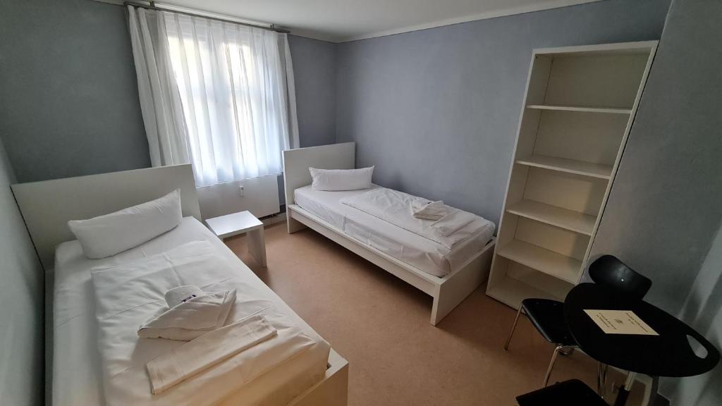 Postel nebo postele na pokoji v ubytování Hotel Cranach-Herberge City Centre