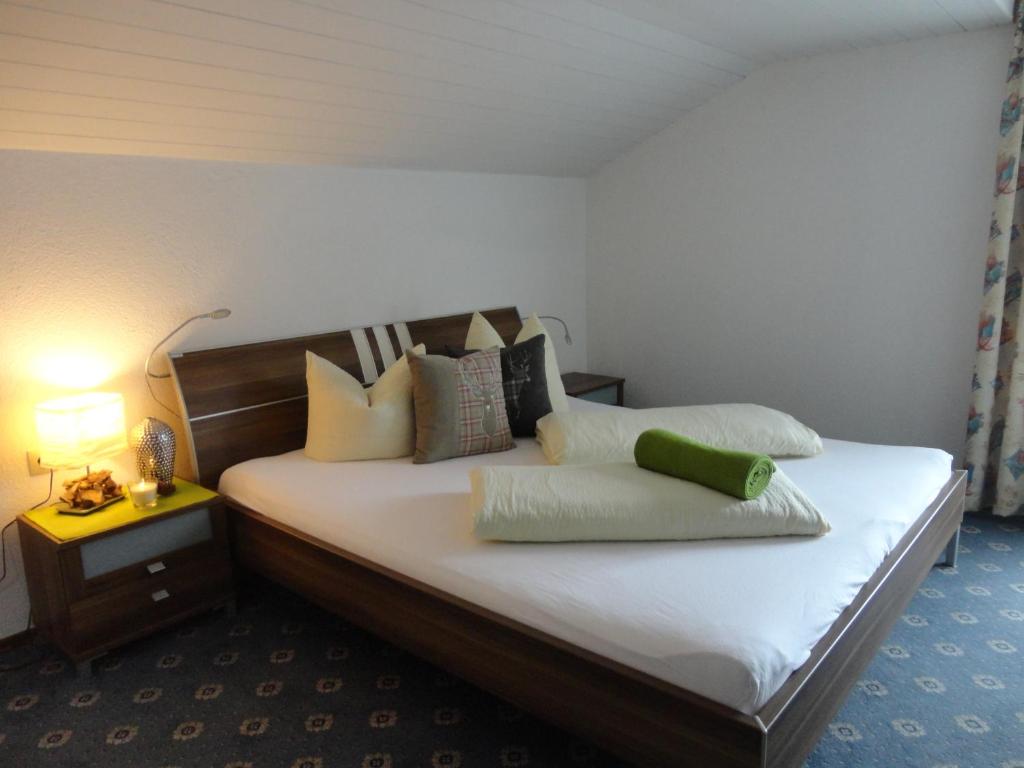 a bedroom with a bed with pillows on it at Wiesenhof in Fügen