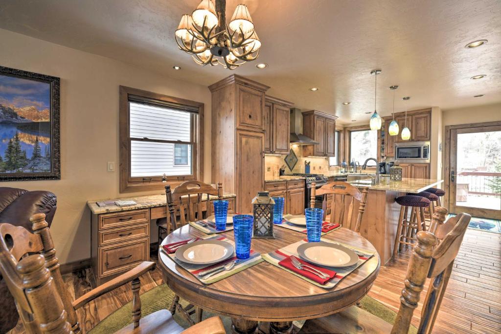 a kitchen with a wooden table and a dining room at Updated Mtn Home with Deck on Uncompahgre River in Ouray