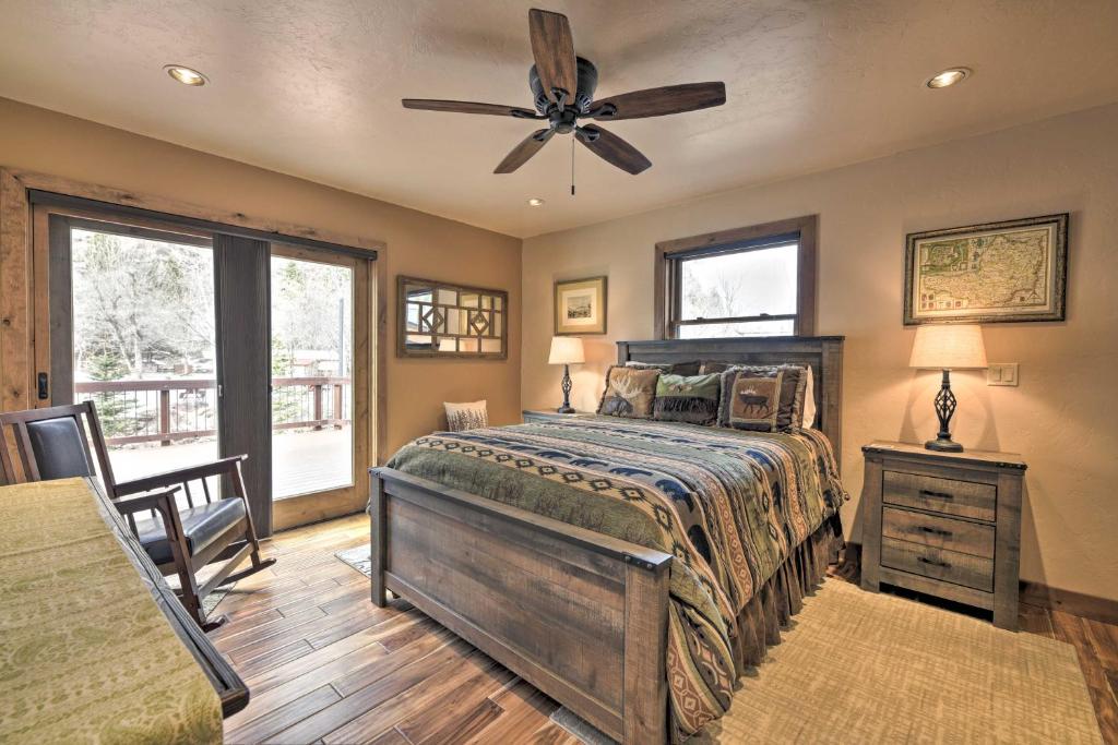 a bedroom with a bed and a ceiling fan at Updated Mtn Home with Deck on Uncompahgre River in Ouray