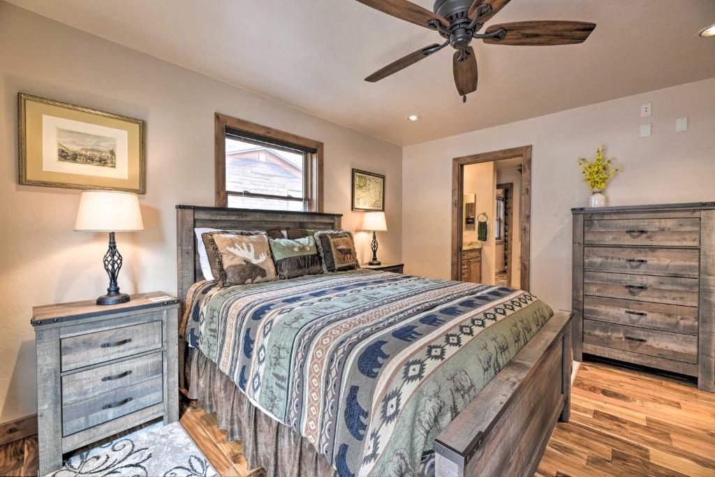 a bedroom with a bed and a ceiling fan at Updated Mtn Home with Deck on Uncompahgre River in Ouray