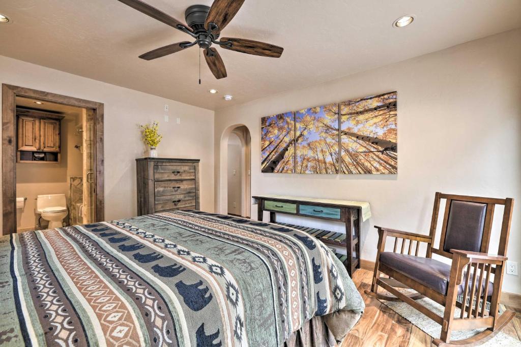 a bedroom with a bed and a ceiling fan at Updated Mtn Home with Deck on Uncompahgre River in Ouray