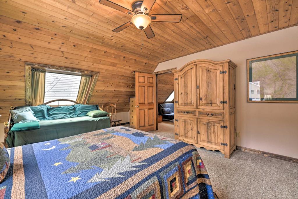 a bedroom with a bed and a wooden ceiling at Updated Mtn Home with Deck on Uncompahgre River in Ouray