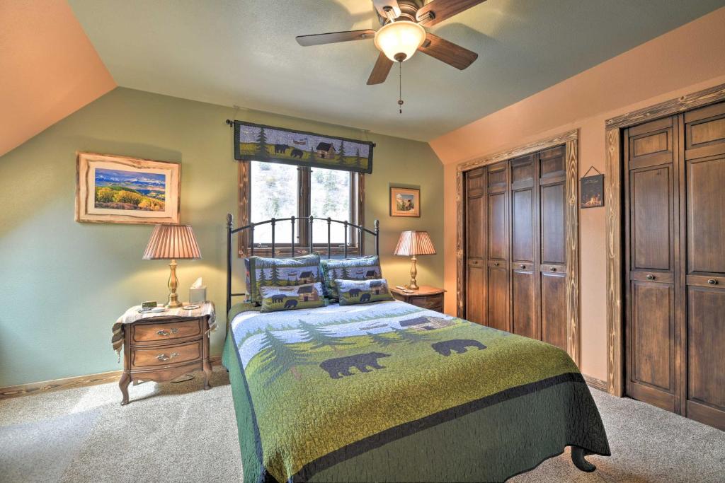 a bedroom with a bed and a ceiling fan at Updated Mtn Home with Deck on Uncompahgre River in Ouray