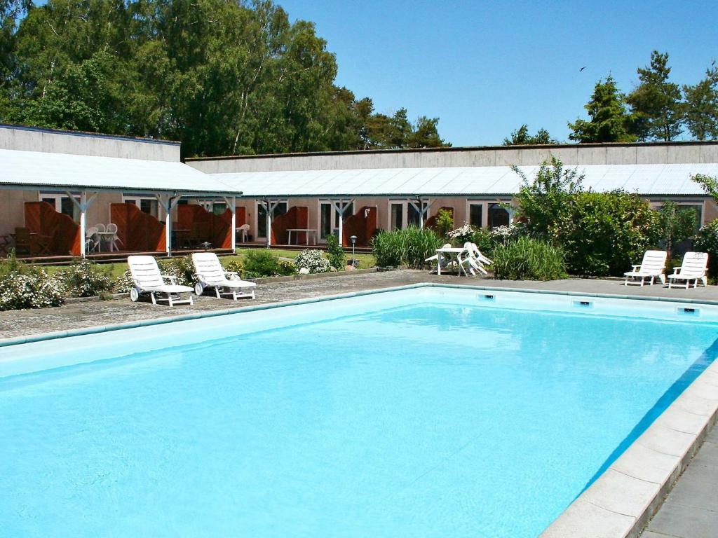 a large swimming pool in front of a house at 4 person holiday home in Nex in Strandby Gårde