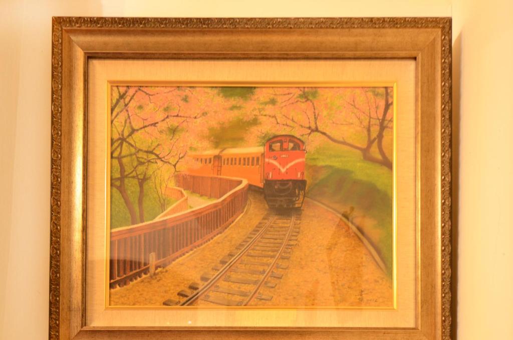 a painting of a train on the tracks at Alishan Fenqihu Green Land Homestay in Guanghua