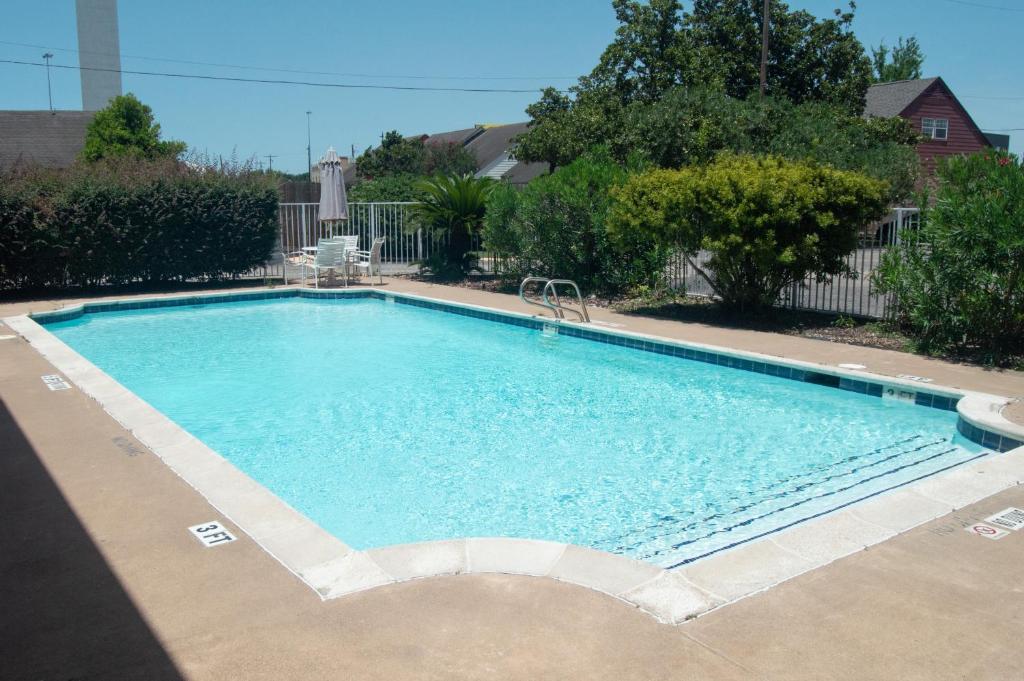 a large swimming pool in a yard at America's Inn Houston in Houston