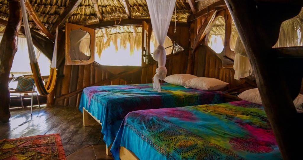 a room with two beds in a tent at La Quinta Orquídea in Puerto Morelos