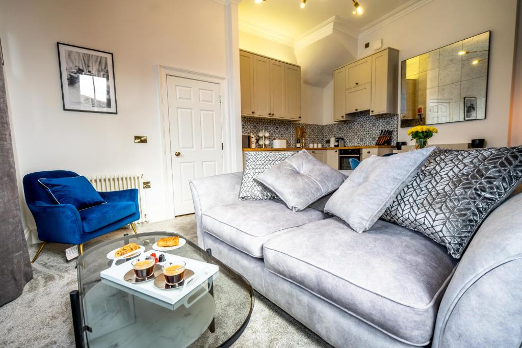 a living room with a couch and a table at 5 Rowntree House in York