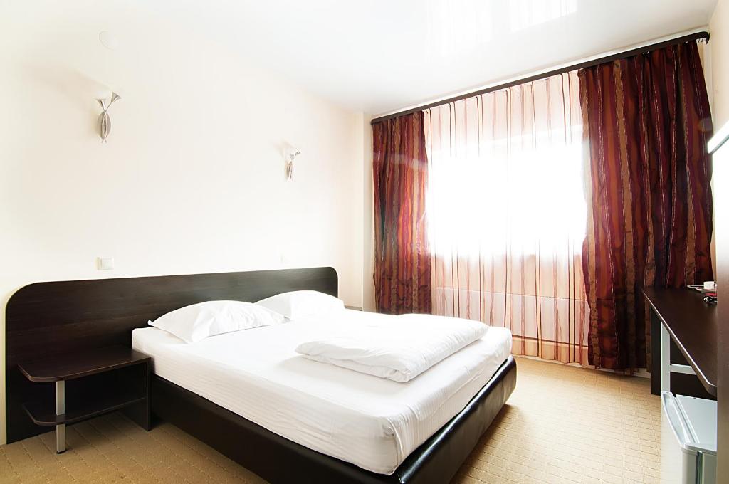 チュメニにあるAstoriaのベッドルーム(ベッド1台、窓付)