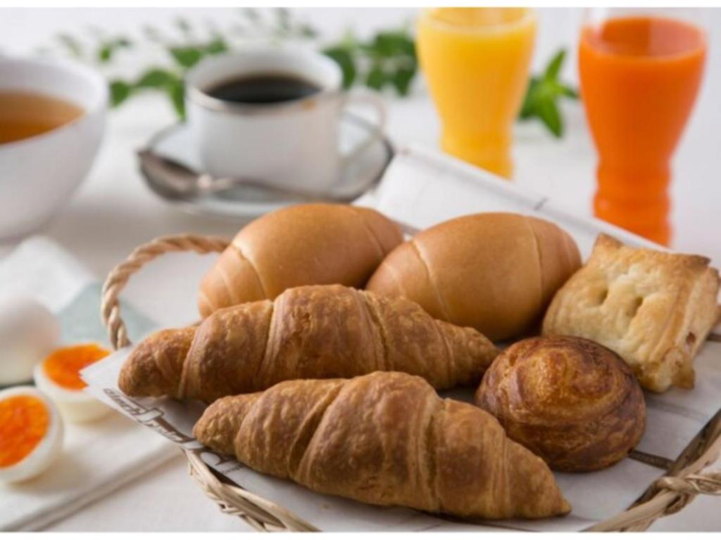 a tray with croissants and croissants and coffee and orange juice at R&B HOTEL HACHIOJI - Vacation STAY 13871v in Hachioji