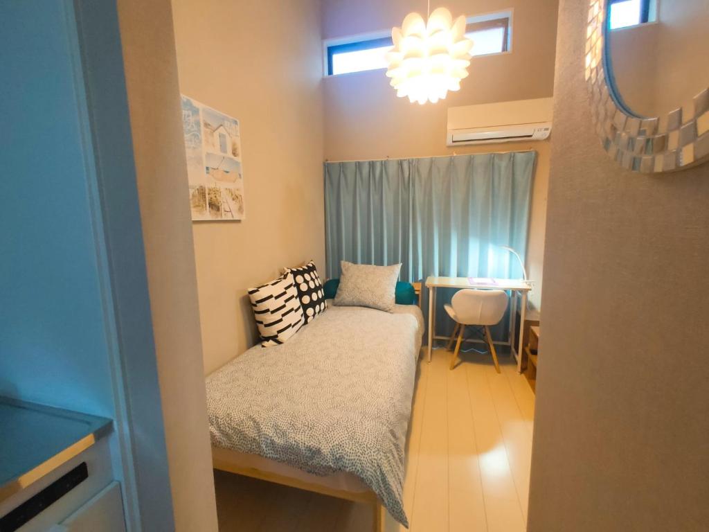 a small bedroom with a bed and a table at MeMe Inn - Vacation STAY 10897 in Saitama