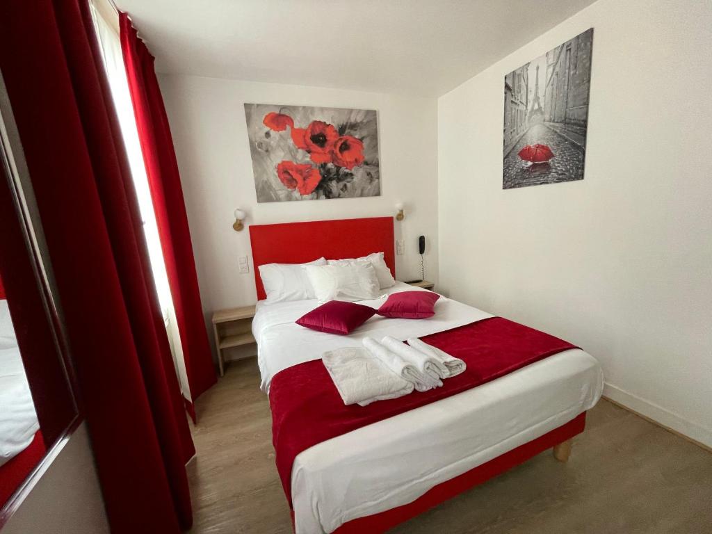 a bedroom with a red and white bed with red pillows at Hôtel de Bordeaux in Paris