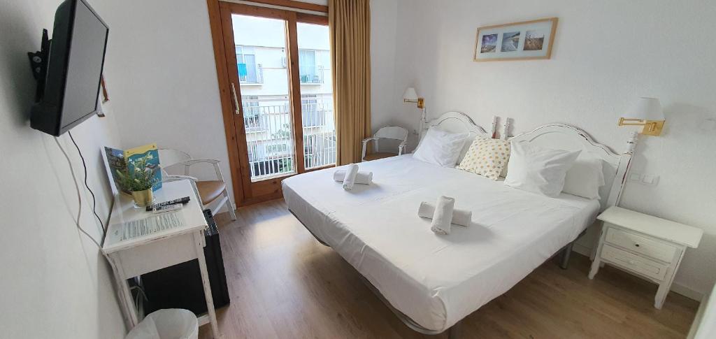 Postel nebo postele na pokoji v ubytování Hotel Mireia