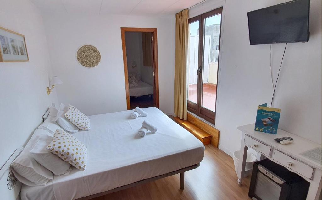Postel nebo postele na pokoji v ubytování Hotel Mireia
