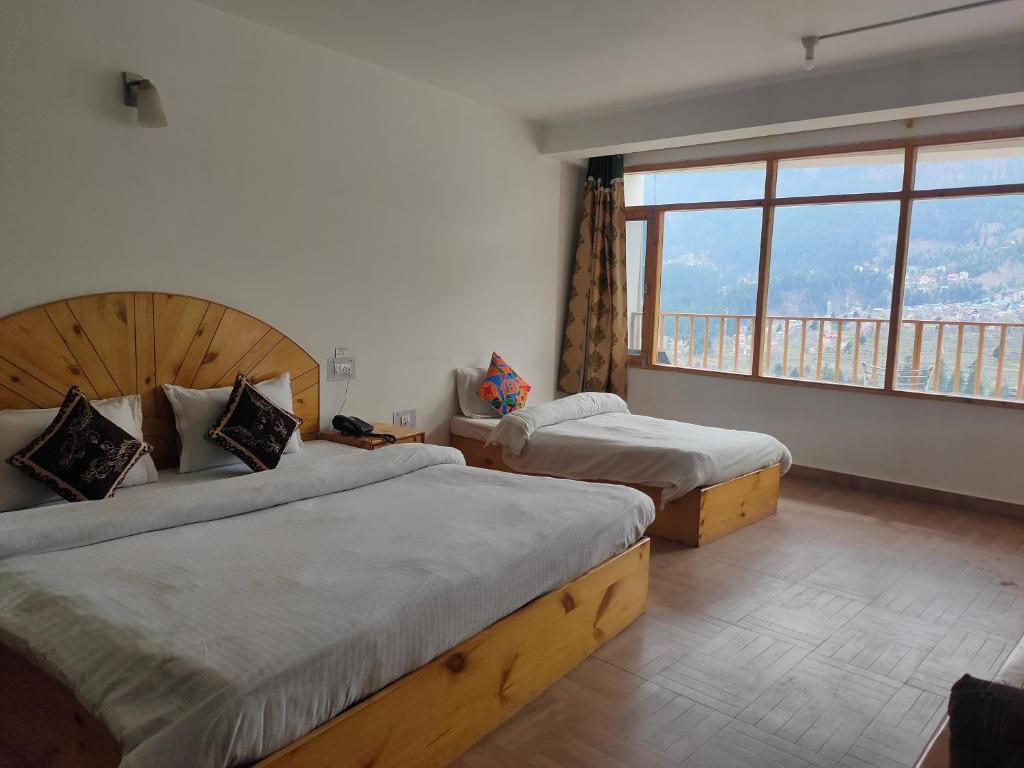 Postel nebo postele na pokoji v ubytování Hotel BHRIGU