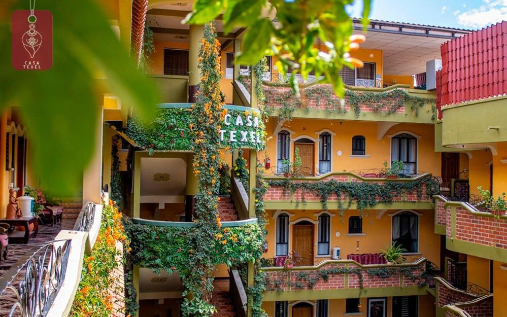 a building with flowers on the side of it at Hotel Casa Texel in Panajachel