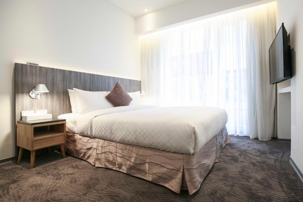Postel nebo postele na pokoji v ubytování Dandy Hotel - Tianjin Branch