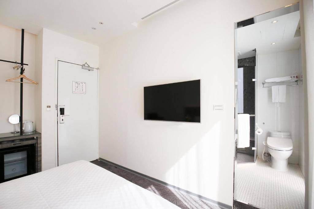 Postel nebo postele na pokoji v ubytování Dandy Hotel - Tianjin Branch