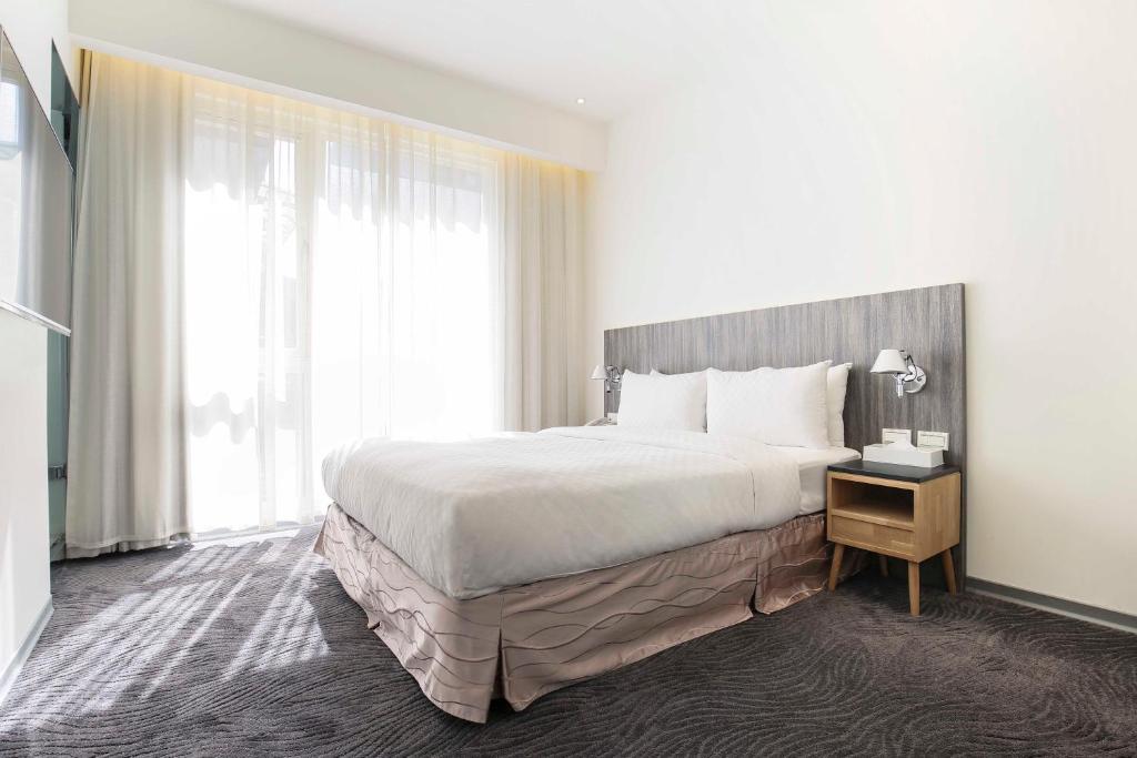 Postel nebo postele na pokoji v ubytování Dandy Hotel - Tianjin Branch