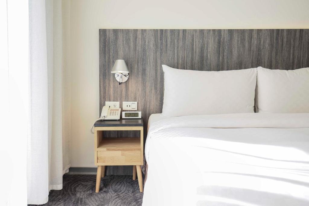 Postel nebo postele na pokoji v ubytování Dandy Hotel - Tianjin Branch