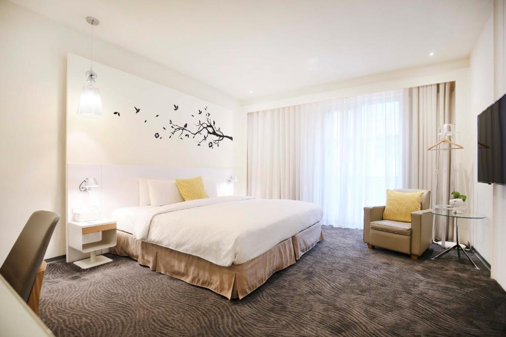 Un pat sau paturi într-o cameră la Dandy Hotel - Tianjin Branch