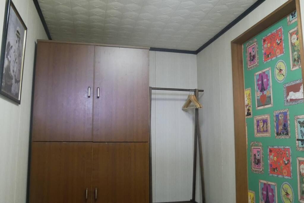 a room with a closet and a wooden cabinet at 民泊 桔梗 in Awaji