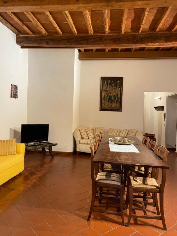 a living room with a table and a couch at Fiesolana 26 in Florence