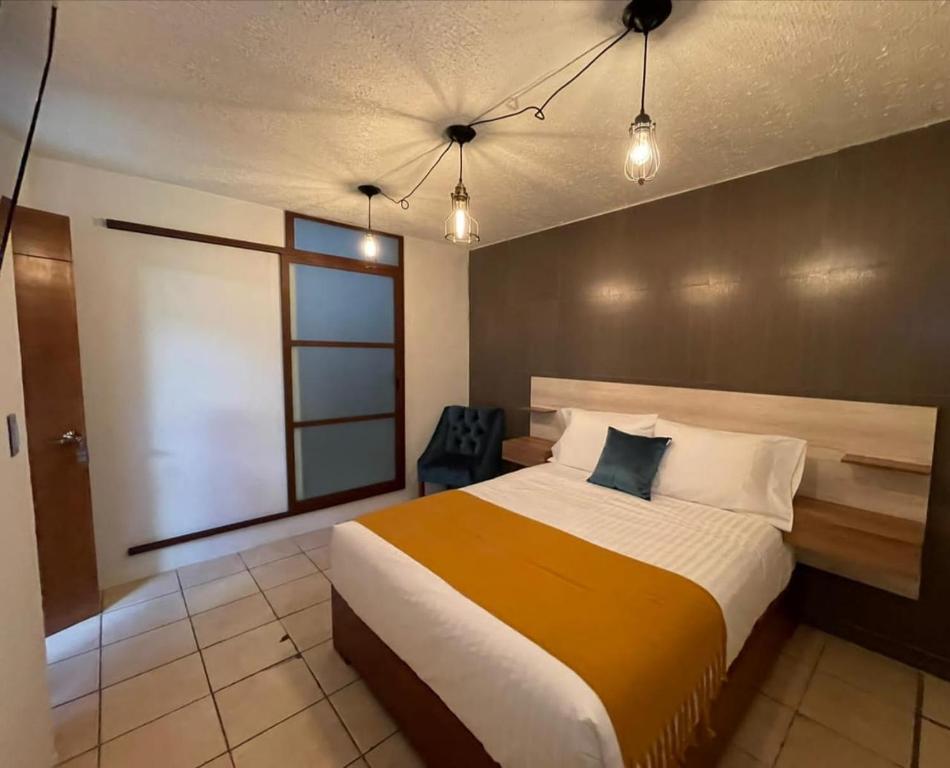 Postel nebo postele na pokoji v ubytování Hotel Orquídea