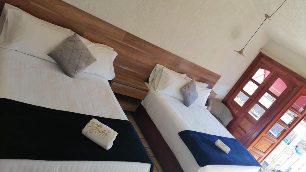 Postel nebo postele na pokoji v ubytování Hotel Orquídea