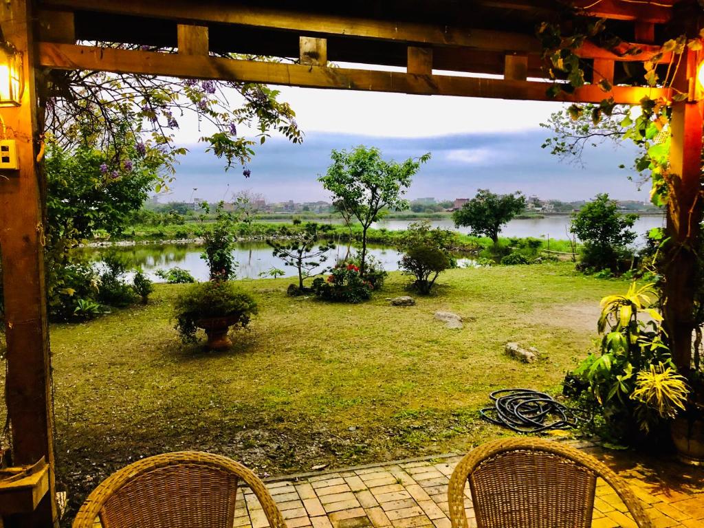 a patio with two chairs and a view of a river at May的家民宿 in Suao