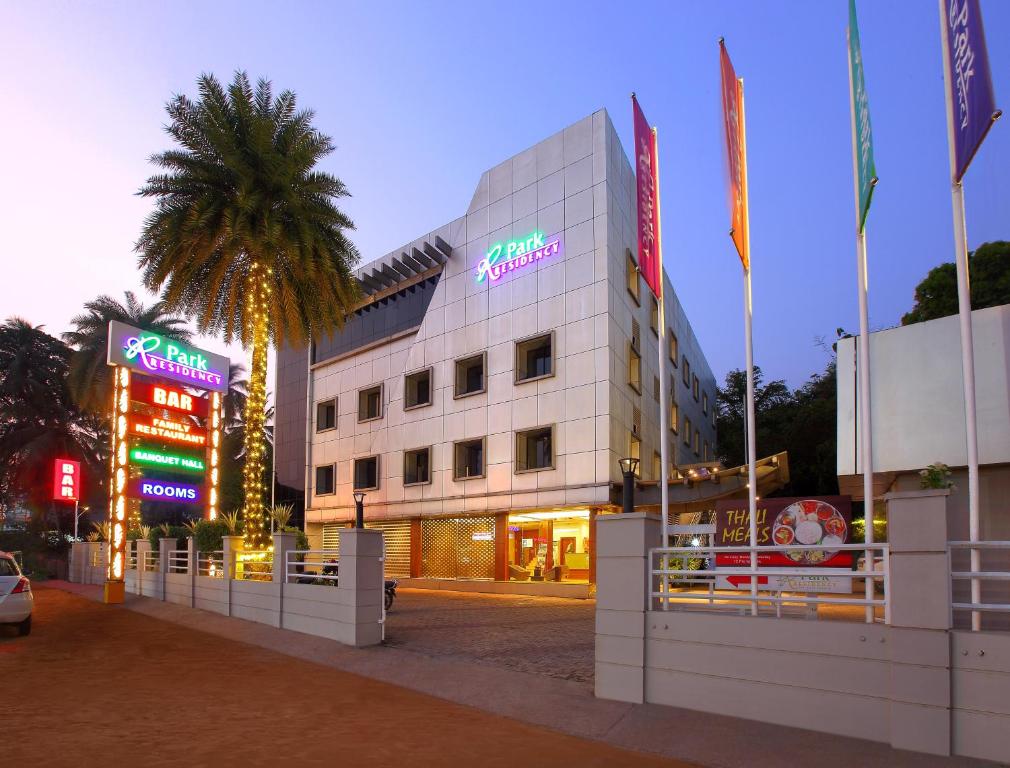 a building with neon signs in front of a street at Park Residency in Kozhikode