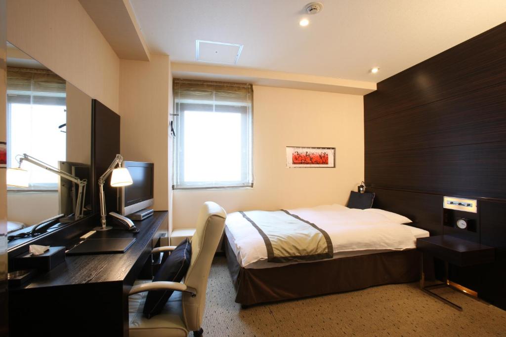 Кровать или кровати в номере My Hotel Ryugu
