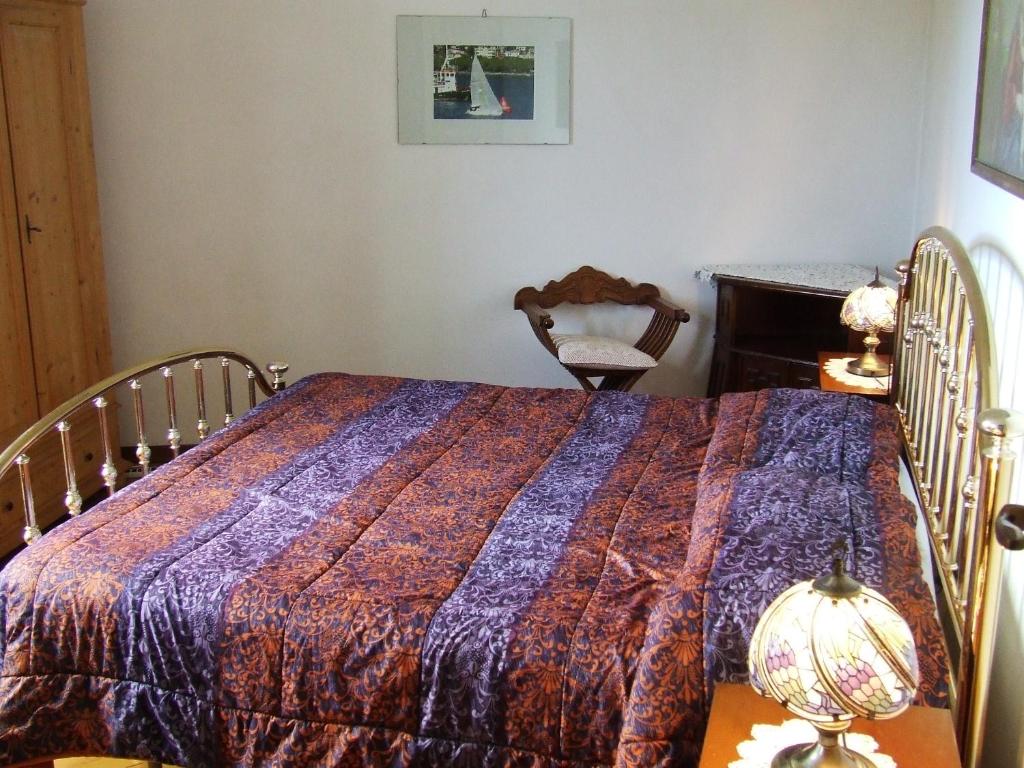 a bedroom with a bed with a blanket on it at Chiara B&b in Trieste