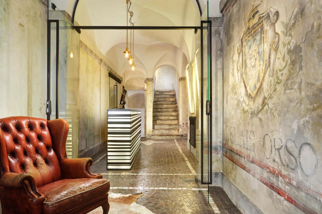 a hallway with a couch and stairs in a building at Relais Orso in Rome