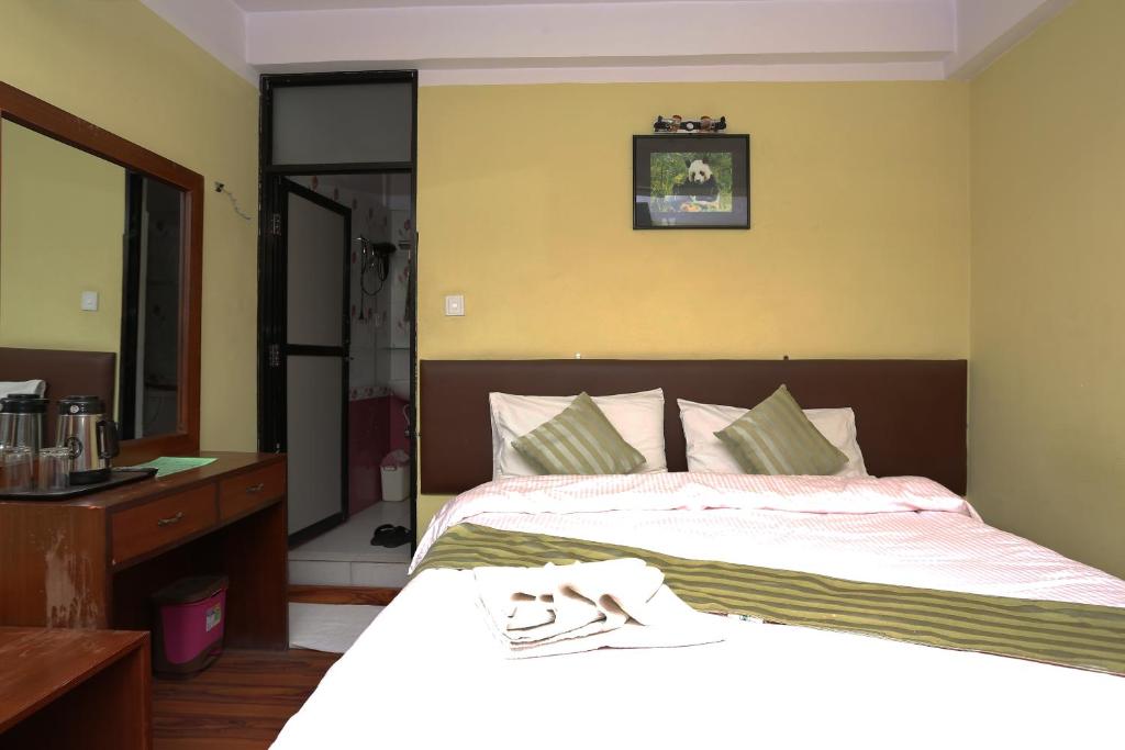 Postel nebo postele na pokoji v ubytování New Hotel Panda