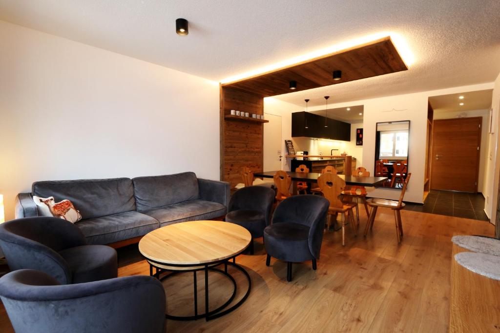 a living room with a couch and chairs and a table at Apollo in Saas-Fee