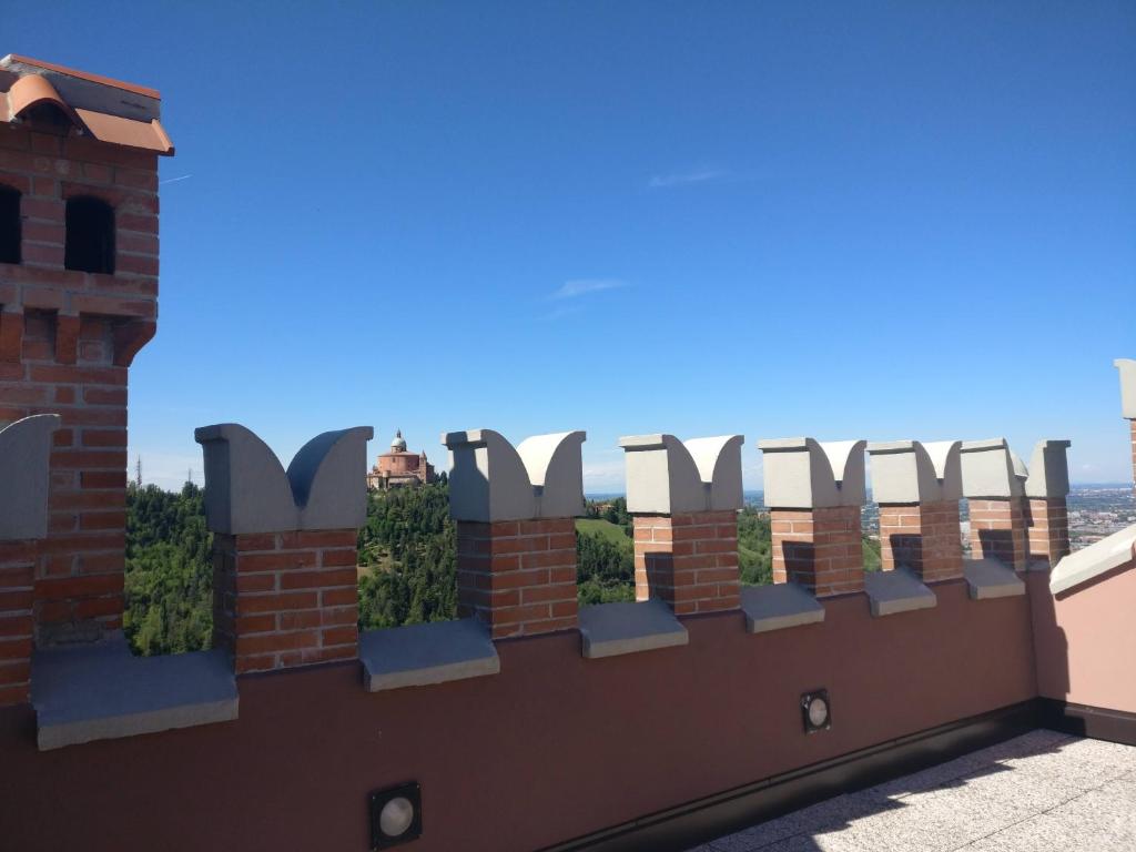 a fence with chairs on top of a building at B&B Poggio San Luca in Bologna