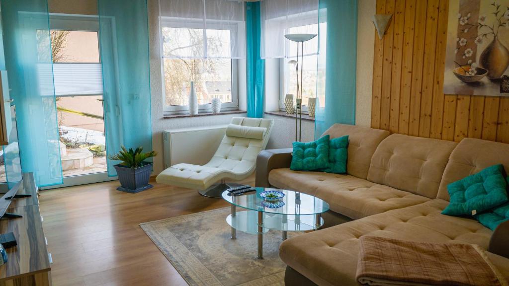 a living room with a couch and a table at Ferienhaus am Osterberg in Quedlinburg