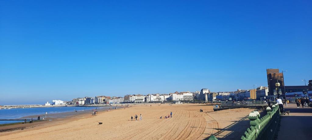 a beach with a group of people on it at Westbrook Lodge Guest House in Margate