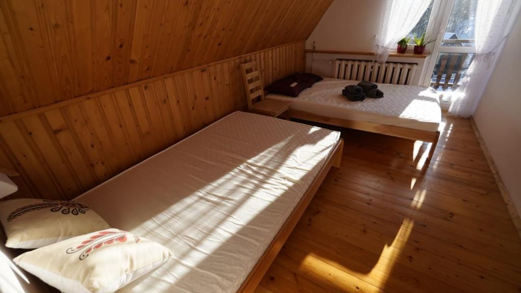 Posteľ alebo postele v izbe v ubytovaní Zawoja Dom Czatoża