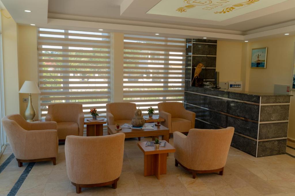 a waiting room with chairs and tables and a counter at Elijah Hotel in Kemer
